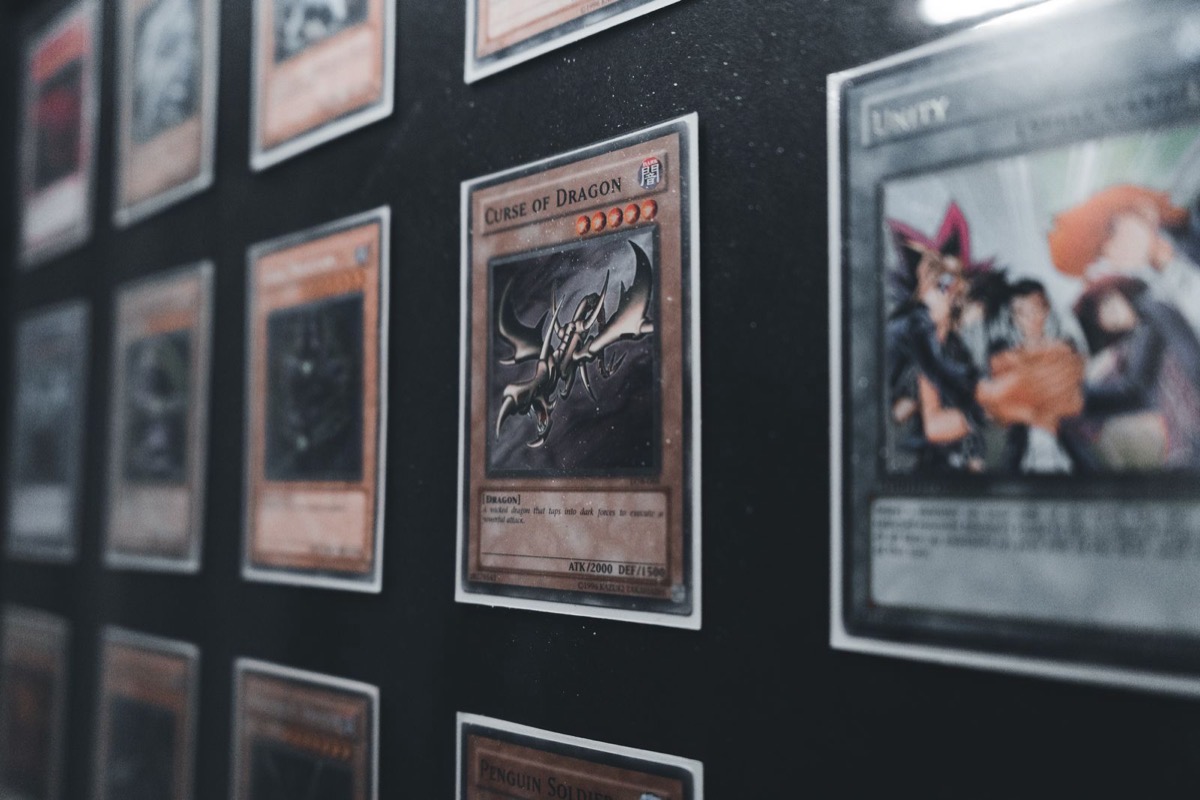 Trading card game cards laid out in rows under dramatic lighting